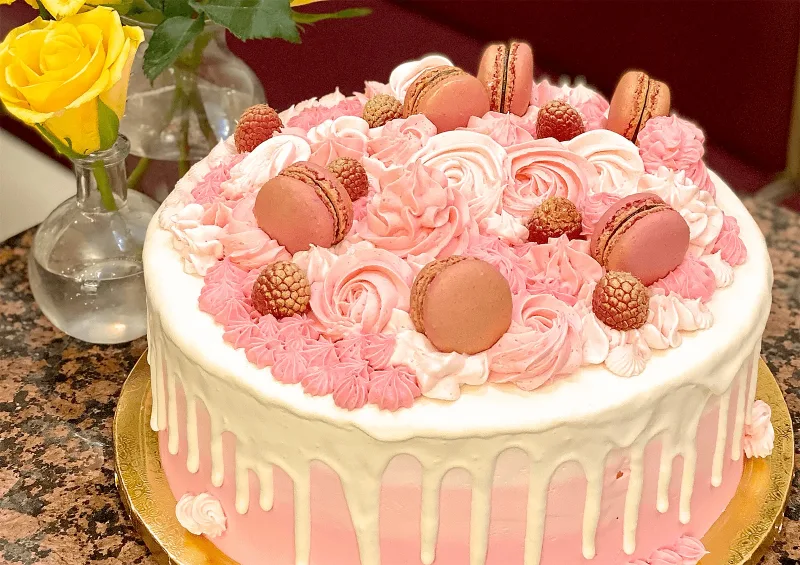 Ombre celebration cake with raspberries and macarons